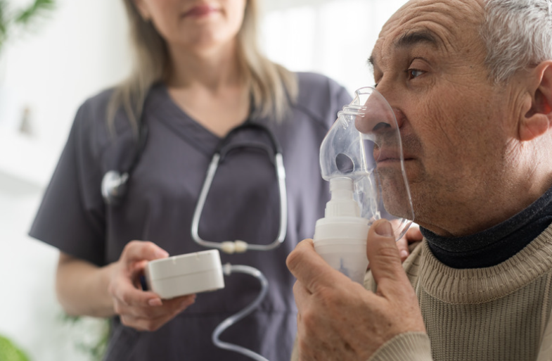 An older gentleman receiving a breathing treatment for respiratory research.